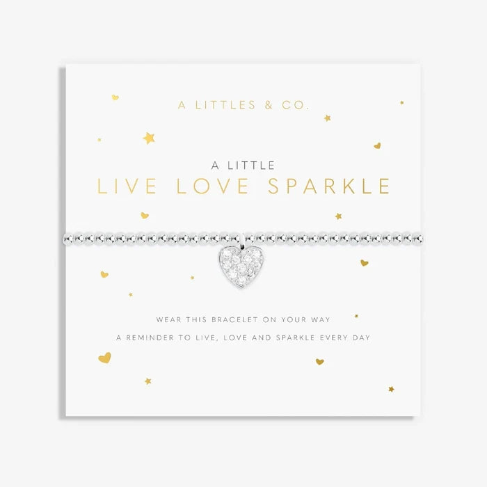 A close-up of a bracelet featuring the words "live," "love," and "sparkle" in a charming design.