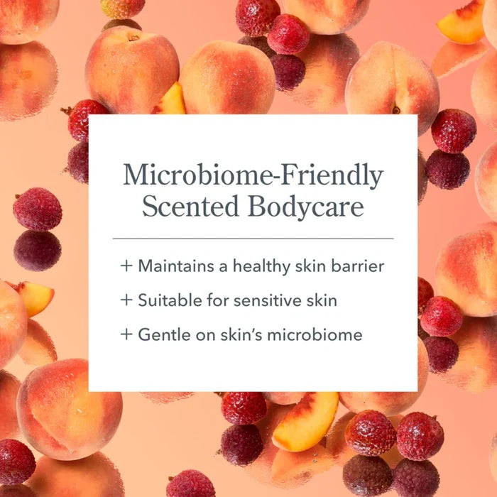 A tube of hand cream alongside oranges and berries, highlighting natural ingredients.