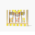 Three tubes of body lotion featuring vibrant lemon and orange designs on their packaging.