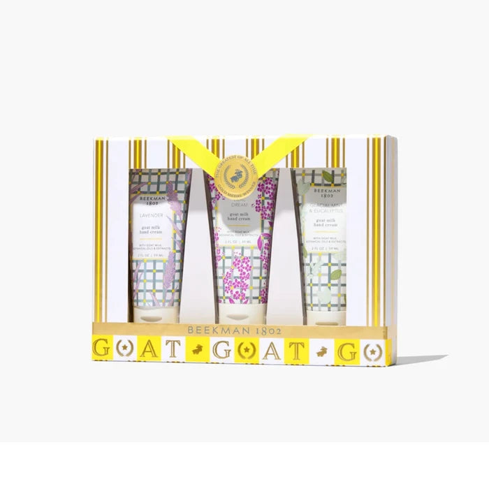 Three hand cream tubes adorned with floral designs, arranged together on a light background.