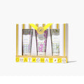 Three hand cream tubes adorned with floral designs, arranged together on a light background.