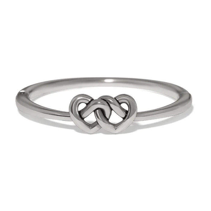 Polished silver Interlok linked hearts hinged bangle featuring intertwined heart motifs with a sleek, elegant design.