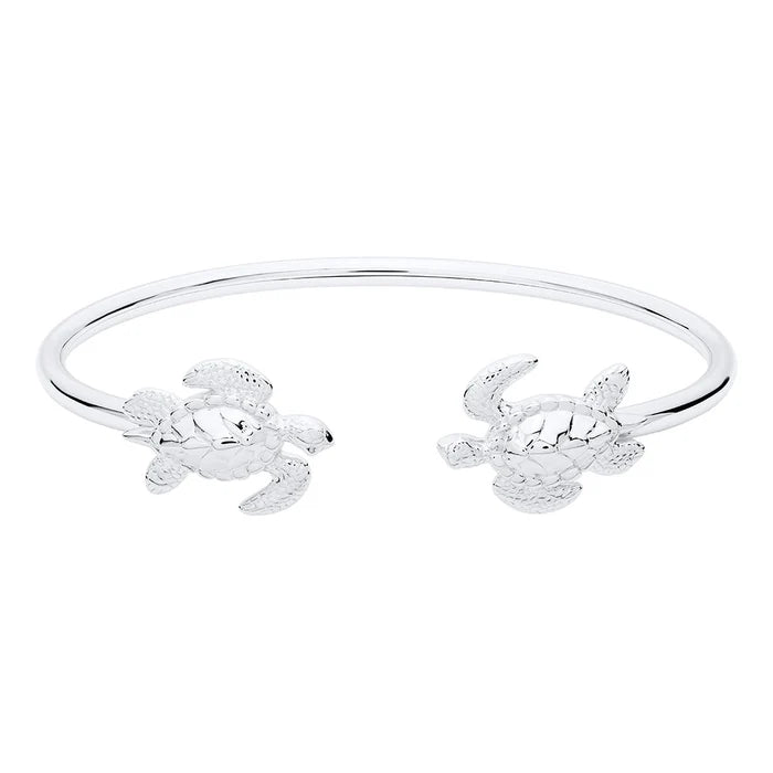 Pair of silver turtle-shaped bangles on a white background