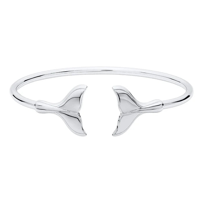 Silver bangle with whale tail design on a white background
