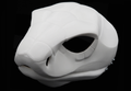 Photo showing a white, plastic 3D printed cobra snake fursuit head base complete with metal hardware at a 3/4 angle against a black background.