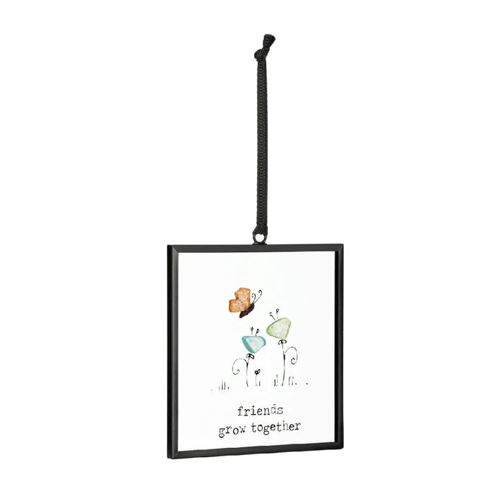 Colorful butterfly ornament with the phrase "friends are like butterflies" displayed on a decorative background.