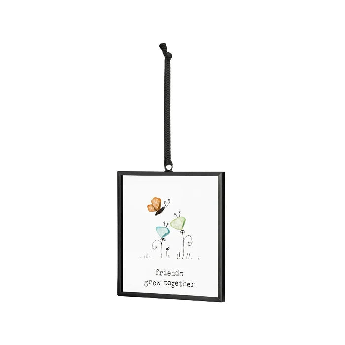 Decorative ornament featuring butterflies and the quote "friends are like butterflies" in a vibrant design.