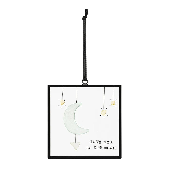 A decorative hanging ornament with the phrase "I love you to the moon and back" in elegant lettering.