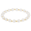 Pearl bracelet with gold accents on a white background