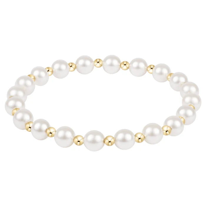 Pearl bracelet with gold accents on a white background