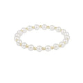 Pearl bracelet with gold accents on a white background