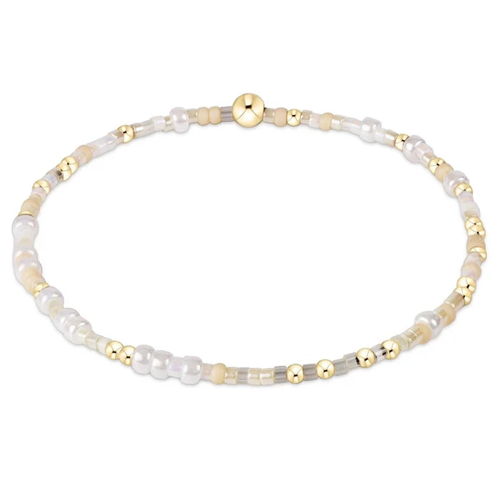 enewton design Hope Unwritten Bracelet featuring Snow color seed beads with 14k gold-filled accents displayed in a circular layout on a white background.