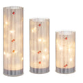 The Ganz LED Light Up Cardinal on Birch Tree Pillar Set features a vibrant red cardinal perched on a beautifully detailed birch tree pillar illuminated by soft LED light.