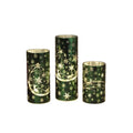 This Gerson Green Lighted Glass Holiday Design Cylinder Luminary brings a warm and festive glow to your Christmas décor.