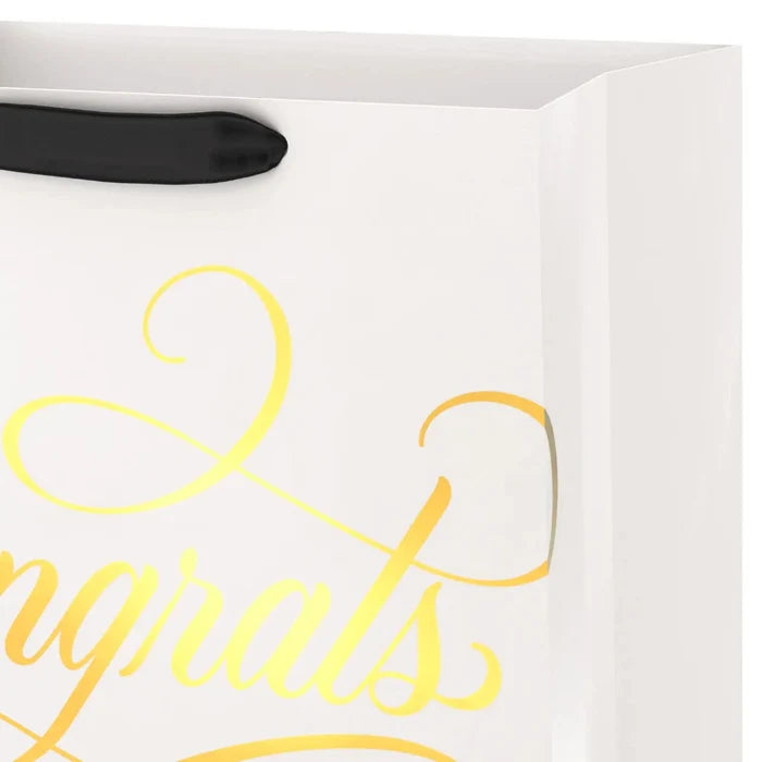 Close‑up of cream and gold “Congrats” gift bag
