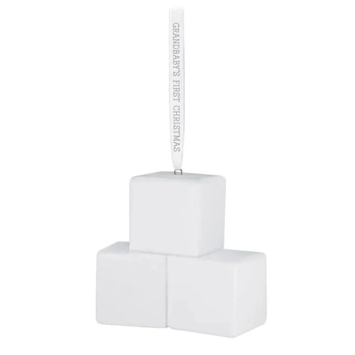 White baby blocks with 'Grandbaby's First Christmas' ribbon on a white background