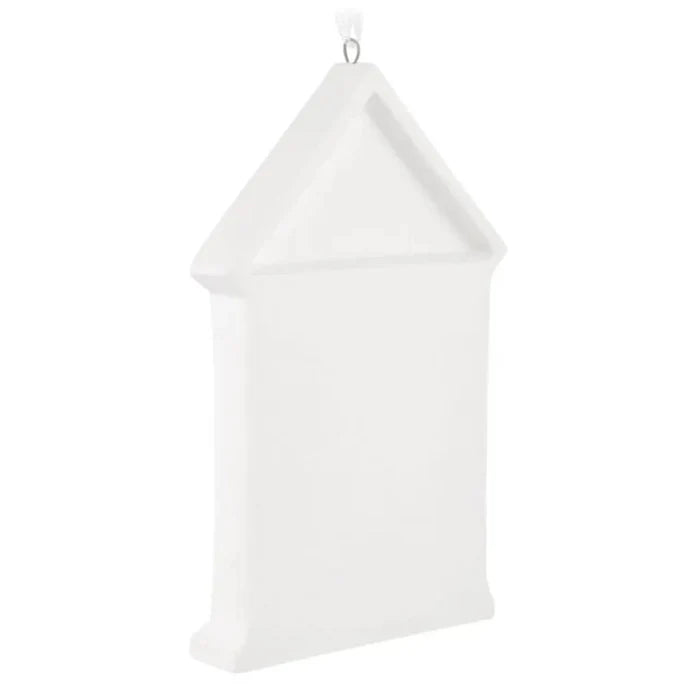 White decorative item resembling a birdhouse on a white background
