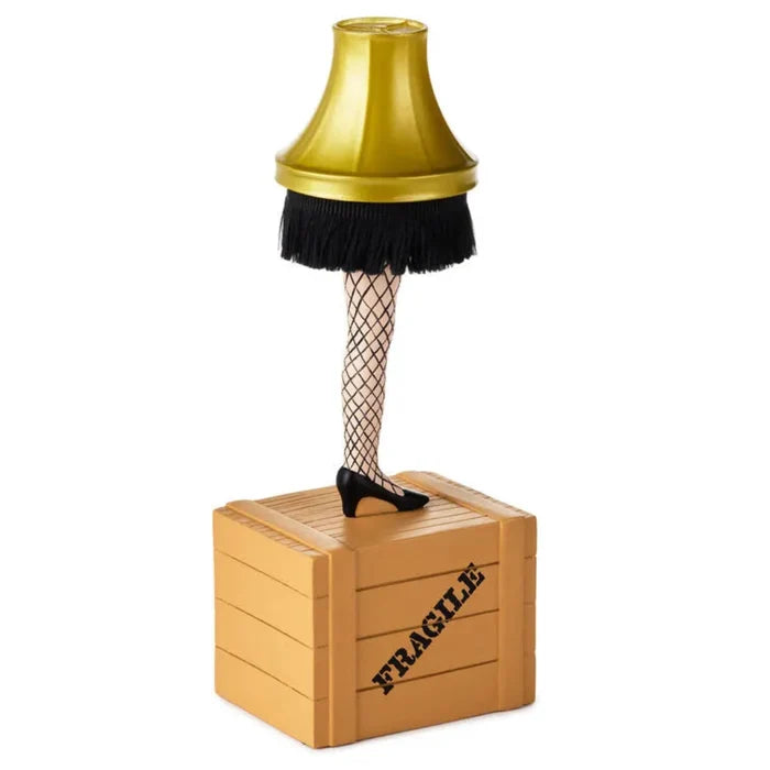 Lamp with a leg on a wooden crate labeled 'Fragile' Count down till Christmas calendar  against a white background
