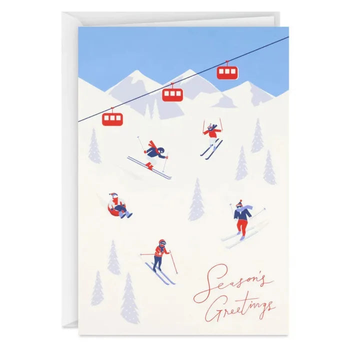 Greeting card with skiers and a ski lift against a mountain backdrop, featuring 'Season's Greetings' text.