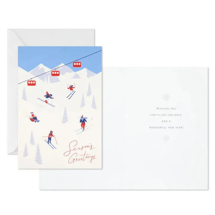 Holiday card with skiers and a ski lift on a snowy mountain, featuring 'Season's Greetings' text.