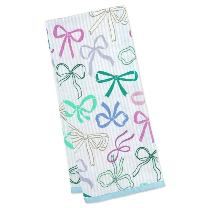 Kitchen towel with colorful bow pattern on a white background
