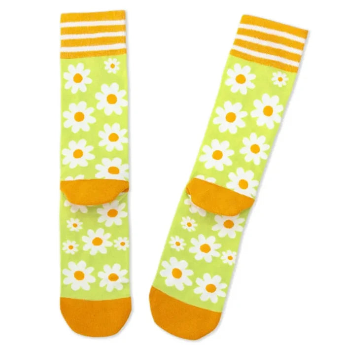 Colorful socks with daisy pattern and orange accents on a white background