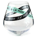 Clear glass with 'Cat Proof' tape wrapped around it on a white background