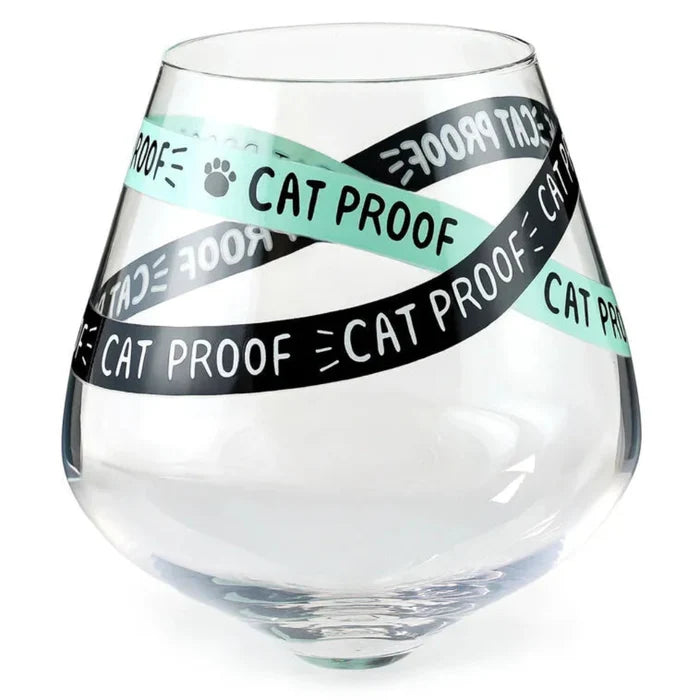 Clear glass with 'Cat Proof' tape wrapped around it on a white background