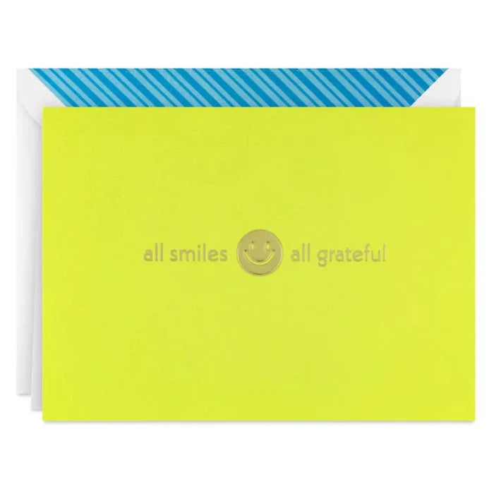 Lime green card with blue border and 'all smiles all grateful' text and smiley face on a white background