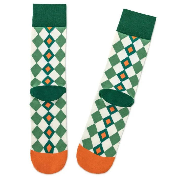 Pair of green and orange patterned socks on a white background