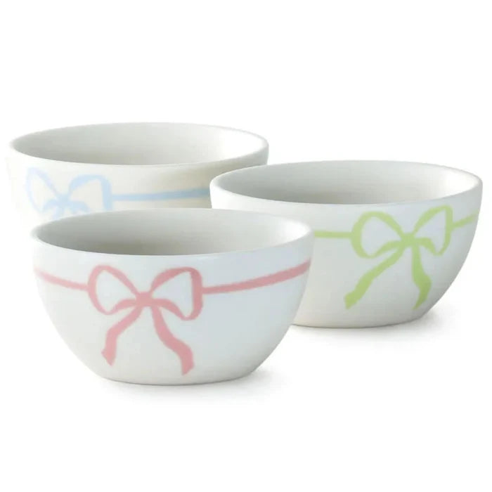 Set of four ceramic bowls with pastel color stripes on a white background
