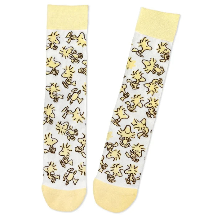 Two socks with yellow cartoon Woodstock character pattern on a white background