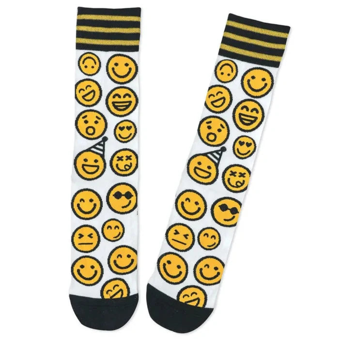 Two socks with yellow smiley face patterns on a white background