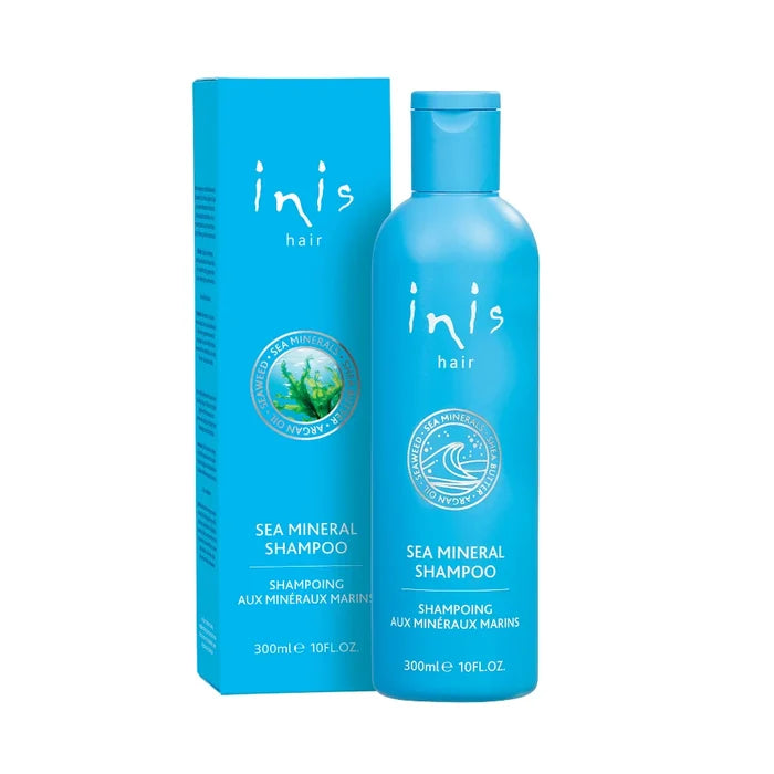 Blue shampoo bottle and box with 'inis hair' branding on a white background