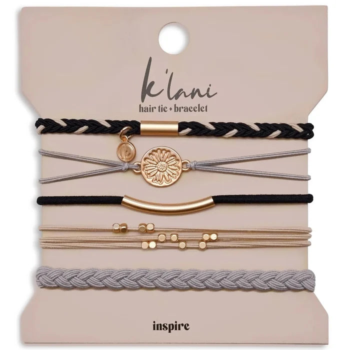 Grey and black hair tie bracelet with a gold flower accent in an elegant Inspire design.
