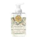 Foaming hand soap bottle with decorative label on a white background