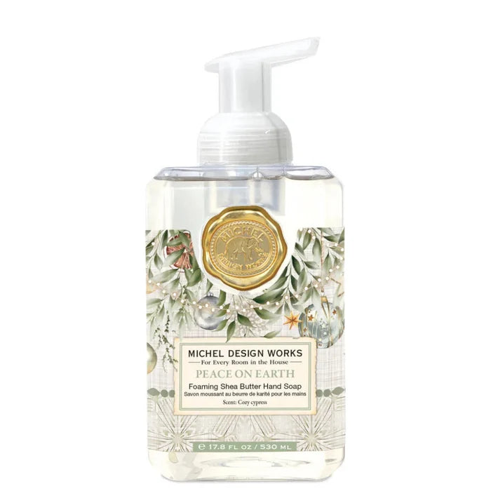 Foaming hand soap bottle with decorative label on a white background