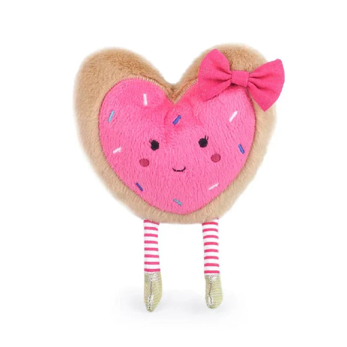 A soft pink heart-shaped stuffed toy featuring a bow, conveying a sense of love and comfort.