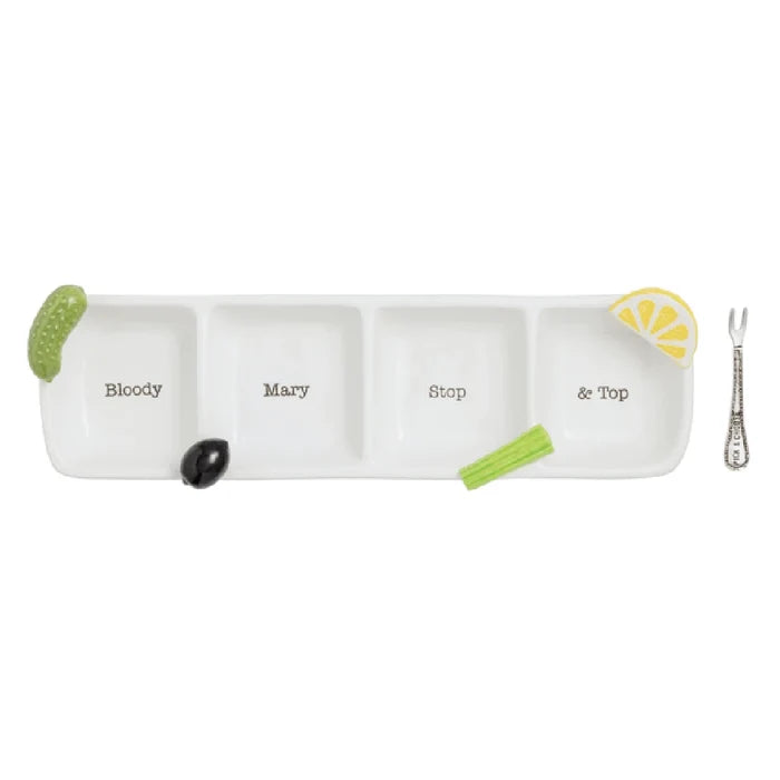 A white tray holds a green and yellow cucumber slice alongside a silver spoon.