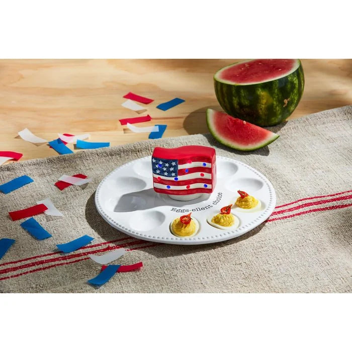 Mud Pie Deviled Egg Tray with light-up flag sitter, deviled eggs, and watermelon on a summer table.