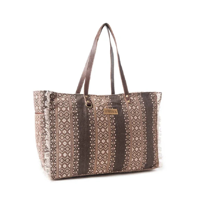 A patterned brown and white tote bag, showcasing a unique design suitable for everyday use and fashion.