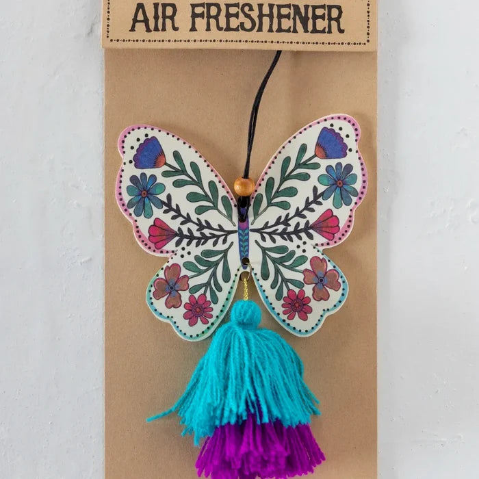 A butterfly-shaped air freshener with a decorative tassel hanging from it.