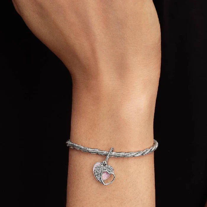 Delicate Pandora heart charm set with pink opal stones, combining beauty and elegance in a unique accessory.
