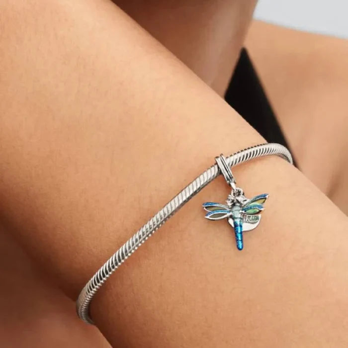 PANDORA Dragonfly Double Dangle Charm in sterling silver with transparent and holographic glitter enamel wings, sparkling stone eyes, and a “Free Spirit” engraved disc for PANDORA Moments bracelets.