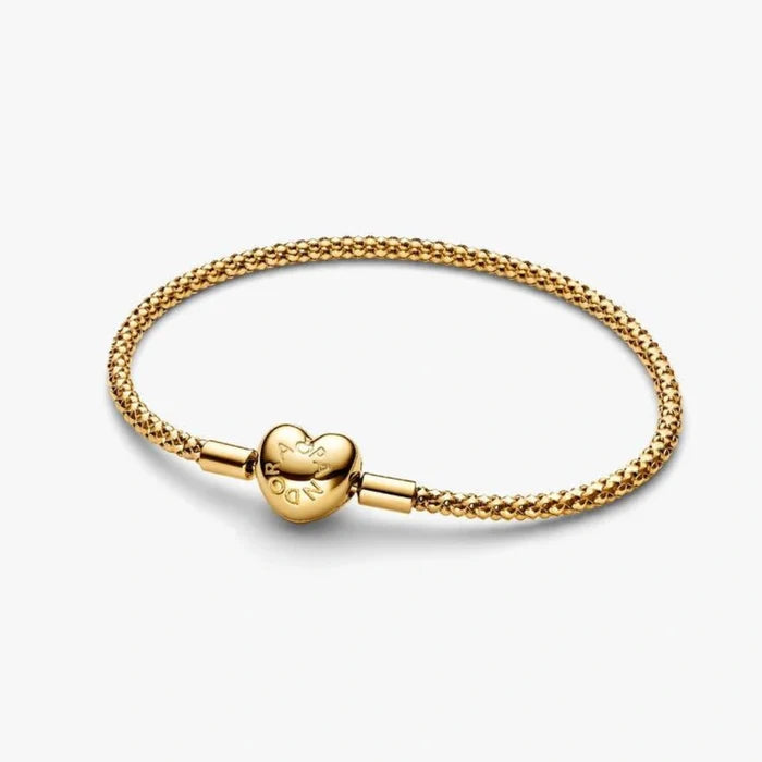 Gold-tone woven mesh chain bracelet with a polished heart-shaped clasp displayed on a white background, perfect for charms and everyday wear.