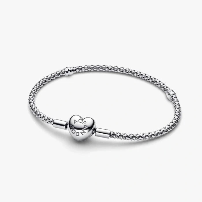 Sterling silver mesh chain bracelet with a polished heart-shaped clasp designed for everyday wear and compatible with charm beads.