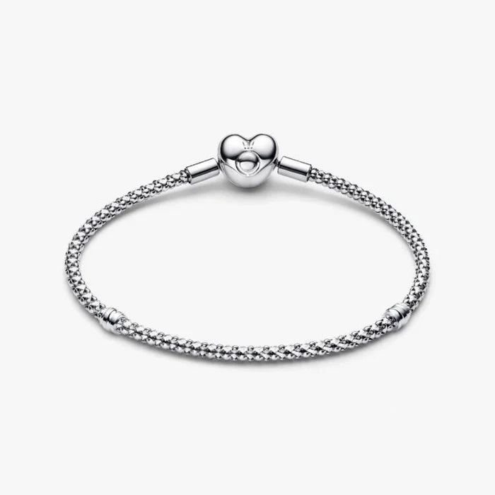 Sterling silver mesh chain bracelet with a polished heart-shaped clasp designed for everyday wear and compatible with charm beads.