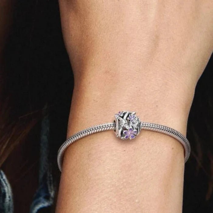 The Pandora Openwork Purple Daisy Charm features a delicate daisy design in rich purple tones.