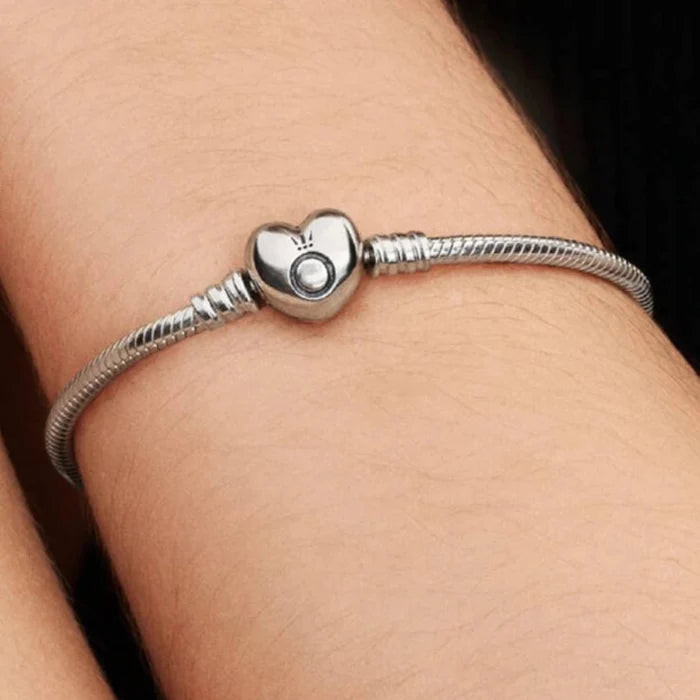 Pandora Moments Heart &amp; Snake Chain Bracelet featuring a polished snake chain with a heart-shaped clasp, designed for Pandora Moments charms and personalized jewelry.