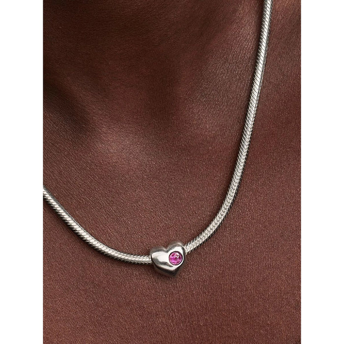 Model wearing Pandora Purple Stone Heart Charm on necklace.